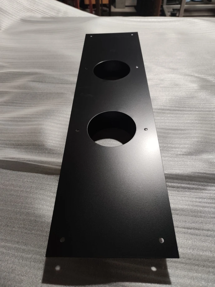 Front of the sheet-metal panel with matte black finish and mounting holes